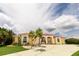 A beautiful yellow single Gathering home with a red tiled roof, arched windows, and a well maintained front yard at 3506 Saint Florent Ct, Punta Gorda, FL 33950