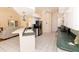 Bright open kitchen with white cabinets, black appliances, breakfast bar and views into the living room at 3506 Saint Florent Ct, Punta Gorda, FL 33950