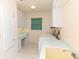 Laundry room with cabinets, countertops, sink, washer, and dryer at 3506 Saint Florent Ct, Punta Gorda, FL 33950