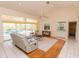 An open-concept living room with sliding glass doors to the pool area, and a built-in bar at 3506 Saint Florent Ct, Punta Gorda, FL 33950