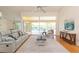 Bright living room showcasing a comfortable seating arrangement and views of the private pool area at 3506 Saint Florent Ct, Punta Gorda, FL 33950