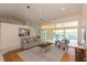 Open-concept living area with a modern couch, connecting seamlessly to the outdoor pool through large windows at 3506 Saint Florent Ct, Punta Gorda, FL 33950