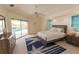 Main bedroom features a calm color palette, ceiling fan and private access to the lanai at 3506 Saint Florent Ct, Punta Gorda, FL 33950