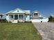 Charming light blue two-story home with a landscaped yard and three-car garage at 3548 Mondovi Ct, Punta Gorda, FL 33950