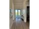 Clean and bright hallway with a glass door leading outside, next to the laundry room at 3548 Mondovi Ct, Punta Gorda, FL 33950