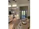 Bright hallway with modern décor, leading to a kitchen and featuring stylish flooring at 3548 Mondovi Ct, Punta Gorda, FL 33950