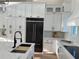 Bright kitchen featuring a large island, black stainless appliances and ample storage at 3548 Mondovi Ct, Punta Gorda, FL 33950