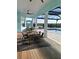 Covered patio with outdoor dining and screened-in pool overlooking the water at 3548 Mondovi Ct, Punta Gorda, FL 33950