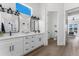 Elegant bathroom boasts dual sinks, modern lighting, and a view into the bedroom and access to the water closet at 3548 Mondovi Ct, Punta Gorda, FL 33950