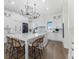 Bright kitchen with white cabinets, quartz countertops, large island with seating, and hardwood floors at 3548 Mondovi Ct, Punta Gorda, FL 33950