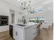 Contemporary kitchen with a spacious island, modern appliances, and an open layout leading to the living area at 3548 Mondovi Ct, Punta Gorda, FL 33950