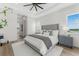 Calm bedroom featuring a king-size bed, hardwood floors, and natural lighting from the nearby window at 3548 Mondovi Ct, Punta Gorda, FL 33950