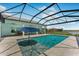 Sparkling swimming pool with clear blue water and an umbrella, set against a screened lanai at 3548 Mondovi Ct, Punta Gorda, FL 33950