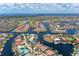 Expansive aerial view showcases the waterfront neighborhood with lush greenery and boat access at 3800 Bal Harbor Blvd # 414, Punta Gorda, FL 33950