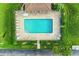 Overhead view of a refreshing pool surrounded by lounge chairs and landscaped greenery at 3800 Bal Harbor Blvd # 414, Punta Gorda, FL 33950