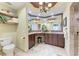 Bathroom includes double sink vanity with granite countertops, tile floors, and wooden ceiling at 3800 Bal Harbor Blvd # 414, Punta Gorda, FL 33950