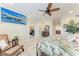 Spacious bedroom with natural light, ceiling fan, TV, wood furniture, tile floor, and comfortable seating at 3800 Bal Harbor Blvd # 414, Punta Gorda, FL 33950