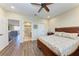 Bedroom showcasing wood floors, a ceiling fan, and access to the bathroom and loft at 3800 Bal Harbor Blvd # 414, Punta Gorda, FL 33950