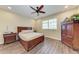 Charming bedroom featuring wood floors, a ceiling fan and an armoire at 3800 Bal Harbor Blvd # 414, Punta Gorda, FL 33950