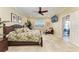 Bedroom with tile flooring, a ceiling fan, and a door leading to the outside at 3800 Bal Harbor Blvd # 414, Punta Gorda, FL 33950