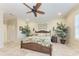 A bright bedroom features a wooden ceiling fan, plants, and tile flooring for a natural aesthetic at 3800 Bal Harbor Blvd # 414, Punta Gorda, FL 33950