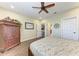 Bedroom with wood floors, ceiling fan, armoire and multiple doors at 3800 Bal Harbor Blvd # 414, Punta Gorda, FL 33950