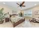 Inviting bedroom features tile flooring, rattan furniture, and a view of the outdoors through the window at 3800 Bal Harbor Blvd # 414, Punta Gorda, FL 33950