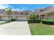 Charming townhome exterior with two-car garage, tile roof, and well-maintained landscaping at 3800 Bal Harbor Blvd # 414, Punta Gorda, FL 33950