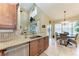 Gourmet kitchen features granite countertops, stainless steel appliances, and bar with a view to the lanai at 3800 Bal Harbor Blvd # 414, Punta Gorda, FL 33950
