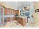 Open concept kitchen showcases granite countertop and custom cabinetry with a view to the second floor at 3800 Bal Harbor Blvd # 414, Punta Gorda, FL 33950