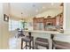 Breakfast bar featuring granite countertop with seating next to a cozy breakfast nook at 3800 Bal Harbor Blvd # 414, Punta Gorda, FL 33950