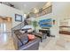 Inviting living room featuring high ceilings, a cozy seating area, and staircase at 3800 Bal Harbor Blvd # 414, Punta Gorda, FL 33950