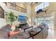 Elegant living room with soaring ceilings, water view, and comfortable leather seating at 3800 Bal Harbor Blvd # 414, Punta Gorda, FL 33950