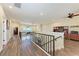 Open loft space featuring wood floors, wrought iron railing and views of home office at 3800 Bal Harbor Blvd # 414, Punta Gorda, FL 33950