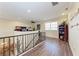 Bright open loft with wood floors and custom railing, perfect for relaxation or productivity at 3800 Bal Harbor Blvd # 414, Punta Gorda, FL 33950