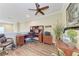 Comfortable home office with wood floors, a ceiling fan, and a large desk with office chair at 3800 Bal Harbor Blvd # 414, Punta Gorda, FL 33950