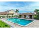 A relaxing community pool is surrounded by lounge chairs and lush landscaping at 3800 Bal Harbor Blvd # 414, Punta Gorda, FL 33950