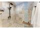 Shower with unique tile patterns, shower head, seat, and white towel on towel rack at 3800 Bal Harbor Blvd # 414, Punta Gorda, FL 33950