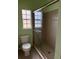 Bathroom featuring a toilet and a glass-enclosed shower next to a small window at 4150 Enclave Pl, Punta Gorda, FL 33980