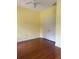 Bedroom with hardwood floors, yellow walls, a ceiling fan, and a white closet door at 4150 Enclave Pl, Punta Gorda, FL 33980