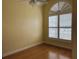 Cozy bedroom with hardwood floors, neutral walls, and a large window with blinds at 4150 Enclave Pl, Punta Gorda, FL 33980