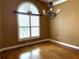 Inviting dining room with hardwood floors, large window with blinds, and elegant chandelier at 4150 Enclave Pl, Punta Gorda, FL 33980