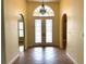 Bright foyer featuring tile flooring, arched doorways and chandelier hanging above double doors at 4150 Enclave Pl, Punta Gorda, FL 33980