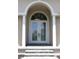 Elegant front entrance featuring double doors, decorative glass, white columns, and a welcoming arched entryway at 4150 Enclave Pl, Punta Gorda, FL 33980