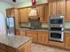 Spacious kitchen featuring wooden cabinets, granite countertops, and stainless steel appliances at 4150 Enclave Pl, Punta Gorda, FL 33980