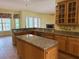Well-equipped kitchen featuring custom cabinets, granite countertops, and an island at 4150 Enclave Pl, Punta Gorda, FL 33980
