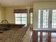 Open kitchen area with granite countertops, stainless steel sink, and bright view to the pool at 4150 Enclave Pl, Punta Gorda, FL 33980