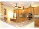 Spacious kitchen featuring custom cabinets, granite countertops and an island at 4150 Enclave Pl, Punta Gorda, FL 33980