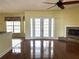 Open living room with wood floors, double doors to the backyard, and a fireplace at 4150 Enclave Pl, Punta Gorda, FL 33980