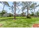 Large, grassy backyard featuring mature trees and a fence at 4346 Rayfield Dr # 4346, Sarasota, FL 34243